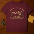 Maroon t-shirt with "Not Lost, Just Taking The Scenic Route" compass graphic.