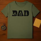 Green t-shirt with black graphic of "DAD" featuring a tent, campfire, and pine tree.