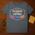 T-shirt with "I'm Coming to the Cottage" and colorful forest design.