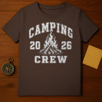Brown t-shirt with distressed "Camping 20 26 Crew" text and campfire graphic.
