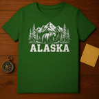 Green t-shirt with distressed graphic of bear, pine trees, and mountains with text ALASKA.