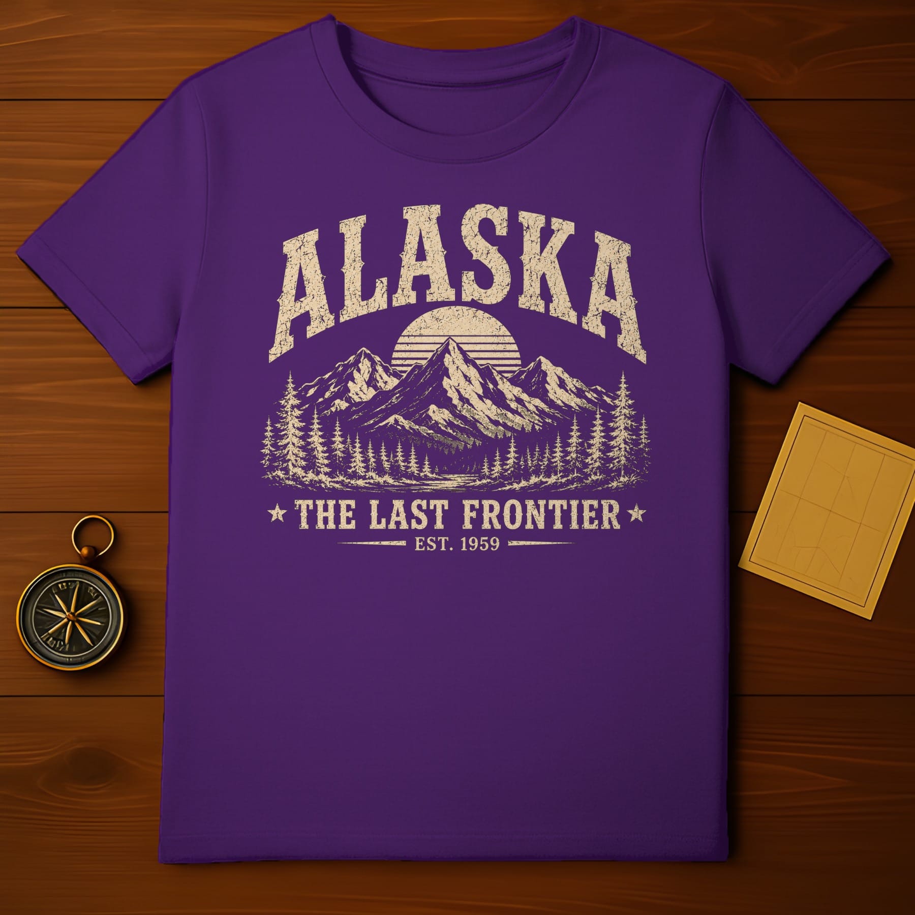 Purple t-shirt with distressed "Alaska The Last Frontier Est. 1959" graphic.