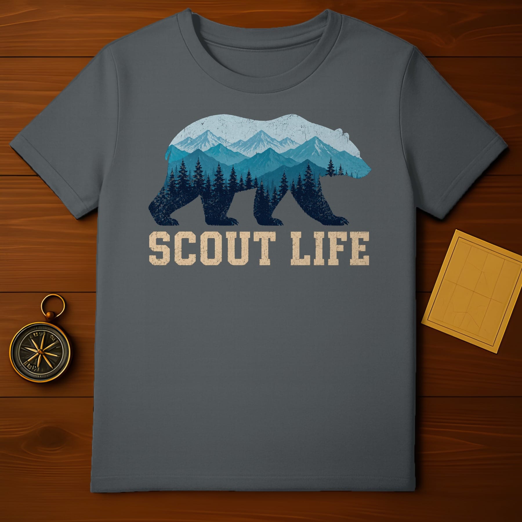 T-shirt with a bear silhouette filled with mountains and trees, text "SCOUT LIFE".