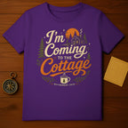 Purple t-shirt with "I'm Coming to the Cottage Retirement 2026" graphic.