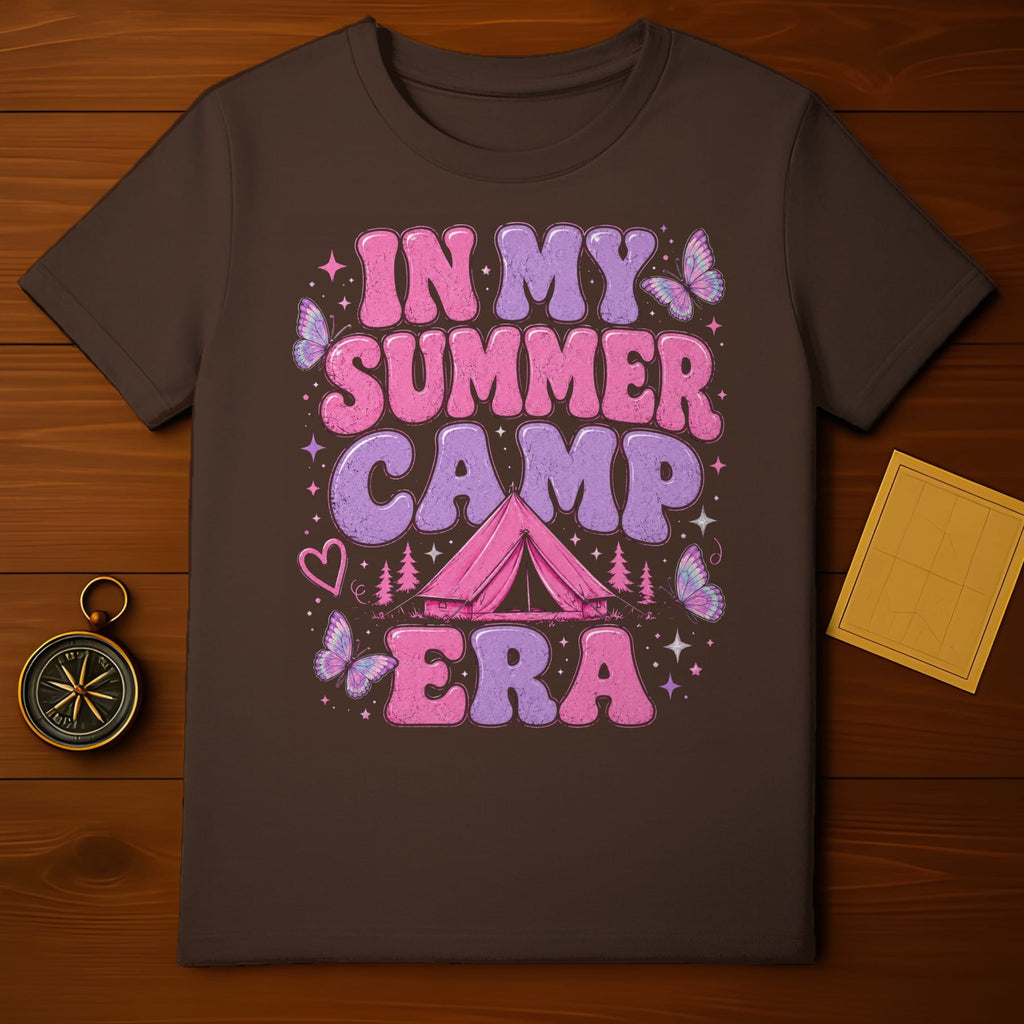 Brown t-shirt with "In My Summer Camp Era" text, tent, pines, hearts, and butterflies.
