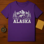 Purple t-shirt with white graphic of bear, trees, and mountains, text "ALASKA".