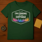 Green t-shirt with "Est 2025 I'm Coming to the Cottage" and colorful trees.