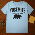 Light blue t-shirt with "YOSEMITE NATIONAL PARK" text and bear silhouette.