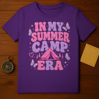 Purple t-shirt with "In My Summer Camp Era" graphic, a tent, and butterflies.