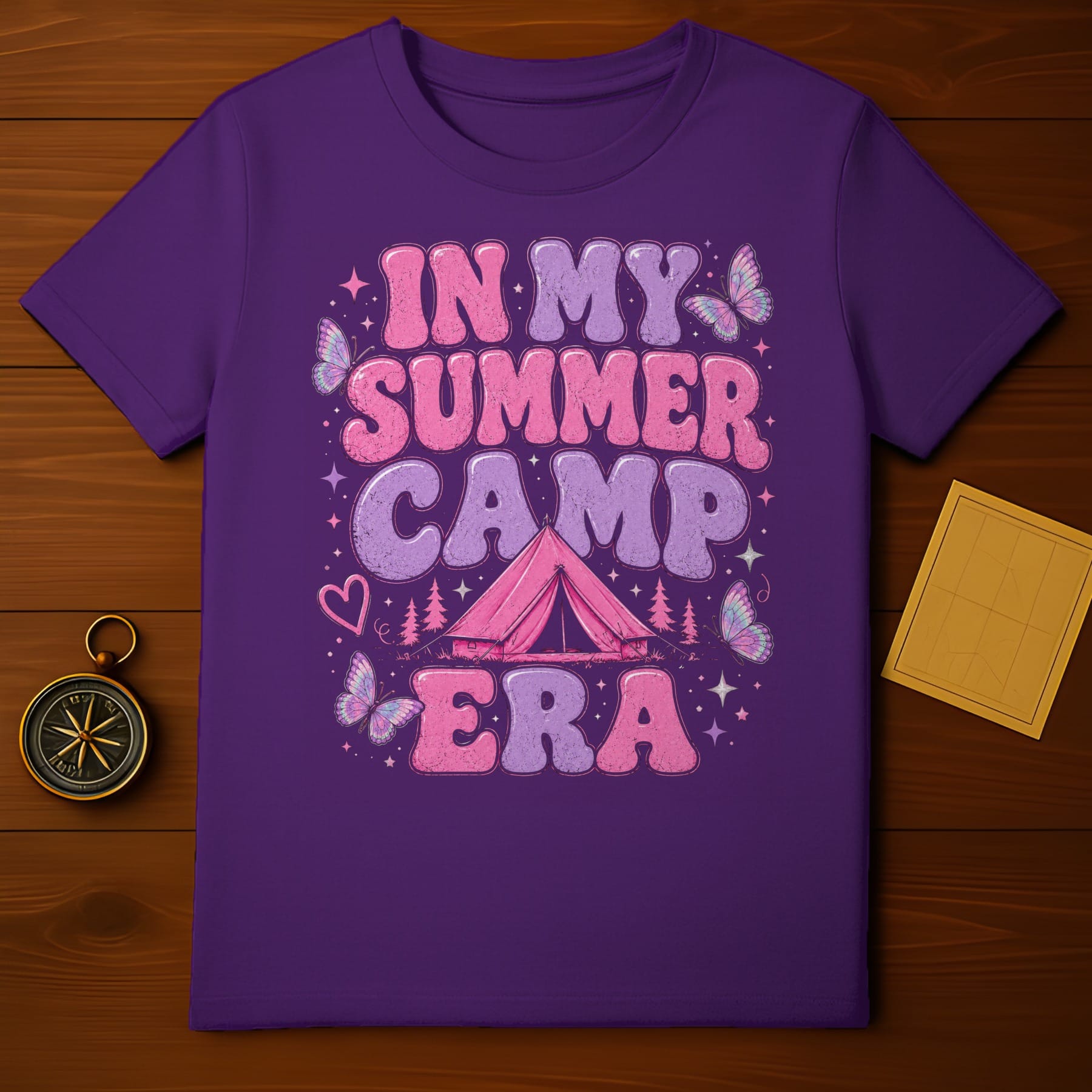 Purple t-shirt with "In My Summer Camp Era" graphic, a tent, and butterflies.