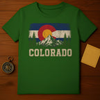 Green t-shirt with distressed Colorado flag graphic and mountains.
