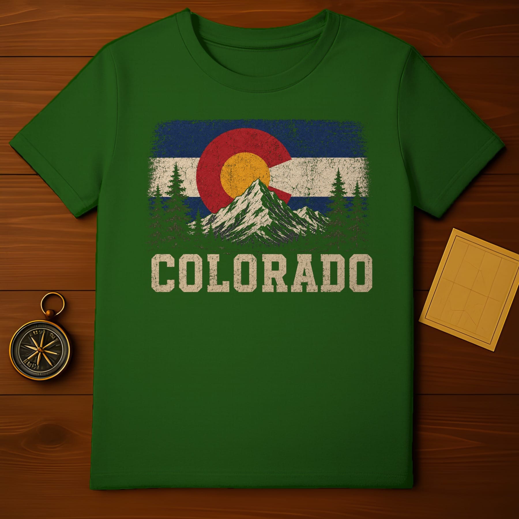 Green t-shirt with distressed Colorado flag graphic and mountains.