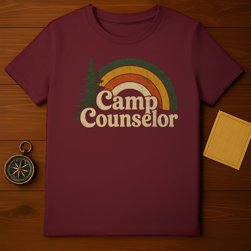 Maroon t-shirt with distressed rainbow and tree graphic reading "Camp Counselor".