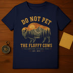 Navy t-shirt with a graphic of a bison, mountains, and sunset, "Do Not Pet The Fluffy Cows Yellowstone National Park" text.