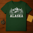 Green t-shirt with bear, pine trees, mountains, and "ALASKA" text.