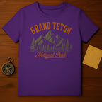 Purple t-shirt with Grand Teton National Park mountain and tree graphic.