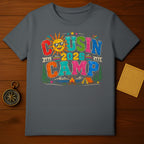 T-shirt graphic saying "Cousin Camp 2026" with a smiling sun and camping scene.