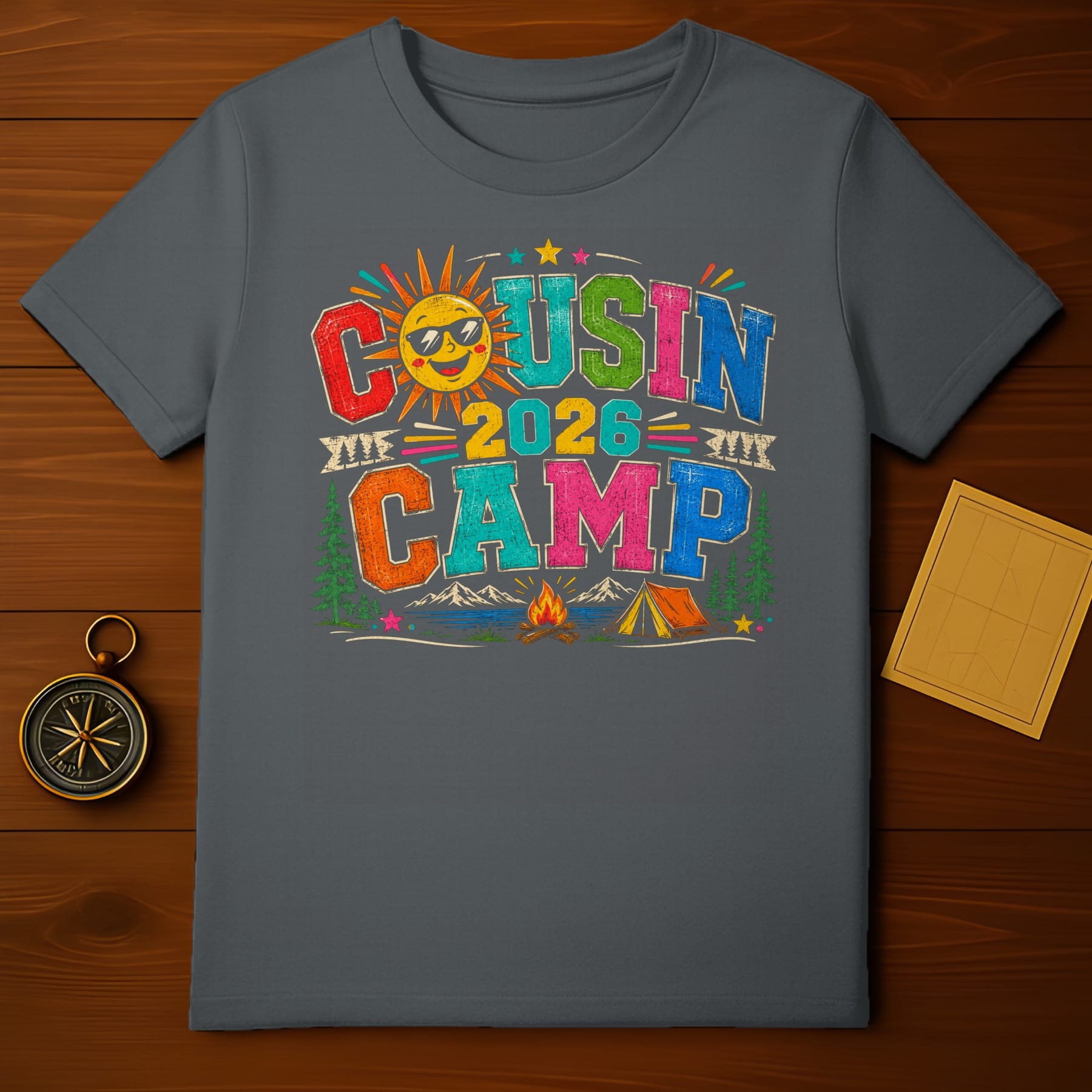 T-shirt graphic saying "Cousin Camp 2026" with a smiling sun and camping scene.