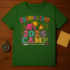 Green t-shirt with "GRANDMA CAMP 2026 CAMP" text and camping graphic.