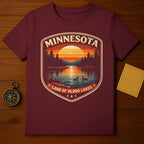 Burgundy t-shirt with a Minnesota sunset landscape design.
