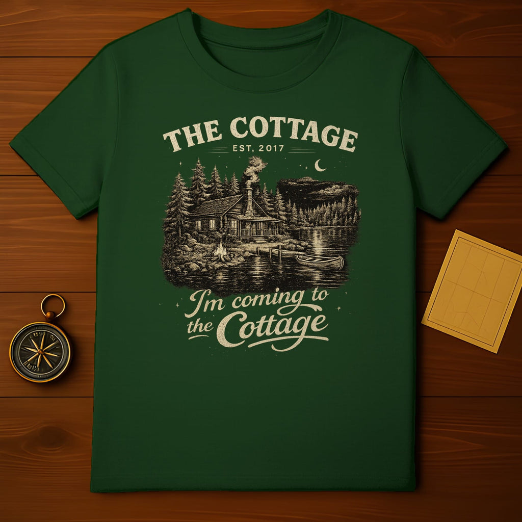 Dark green t-shirt with "The Cottage" graphic featuring a cabin, lake, and stars.