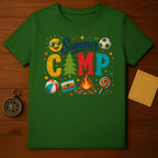 Green t-shirt with "Summer Camp" text, sun, soccer ball, beach ball, campfire, and lollipop.