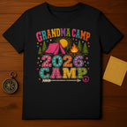 Black t-shirt with "Grandma Camp 2026 Camp" graphic featuring a tent, campfire, and peace sign.