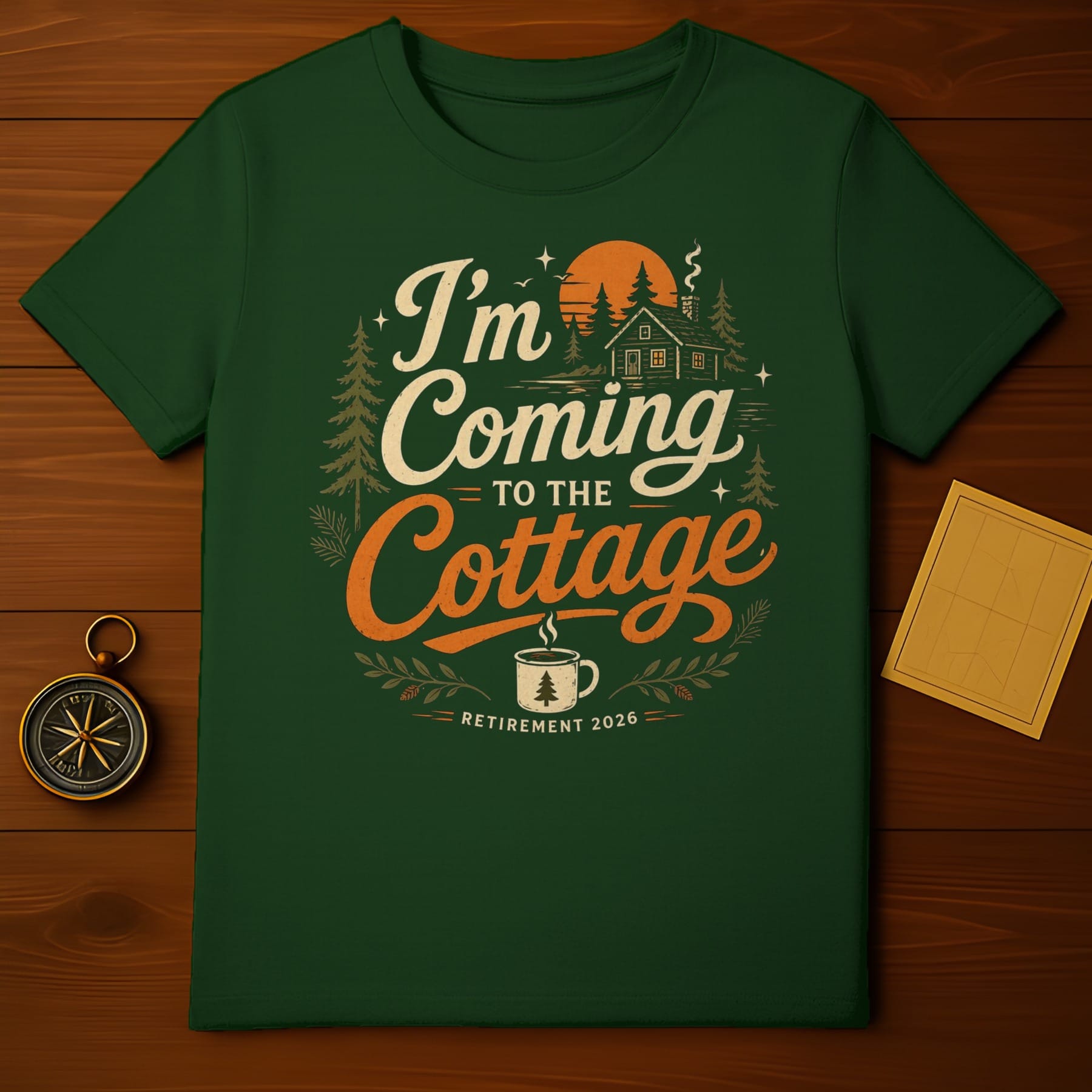 Green t-shirt with "I'm Coming to the Cottage Retirement 2026" text and forest scene.