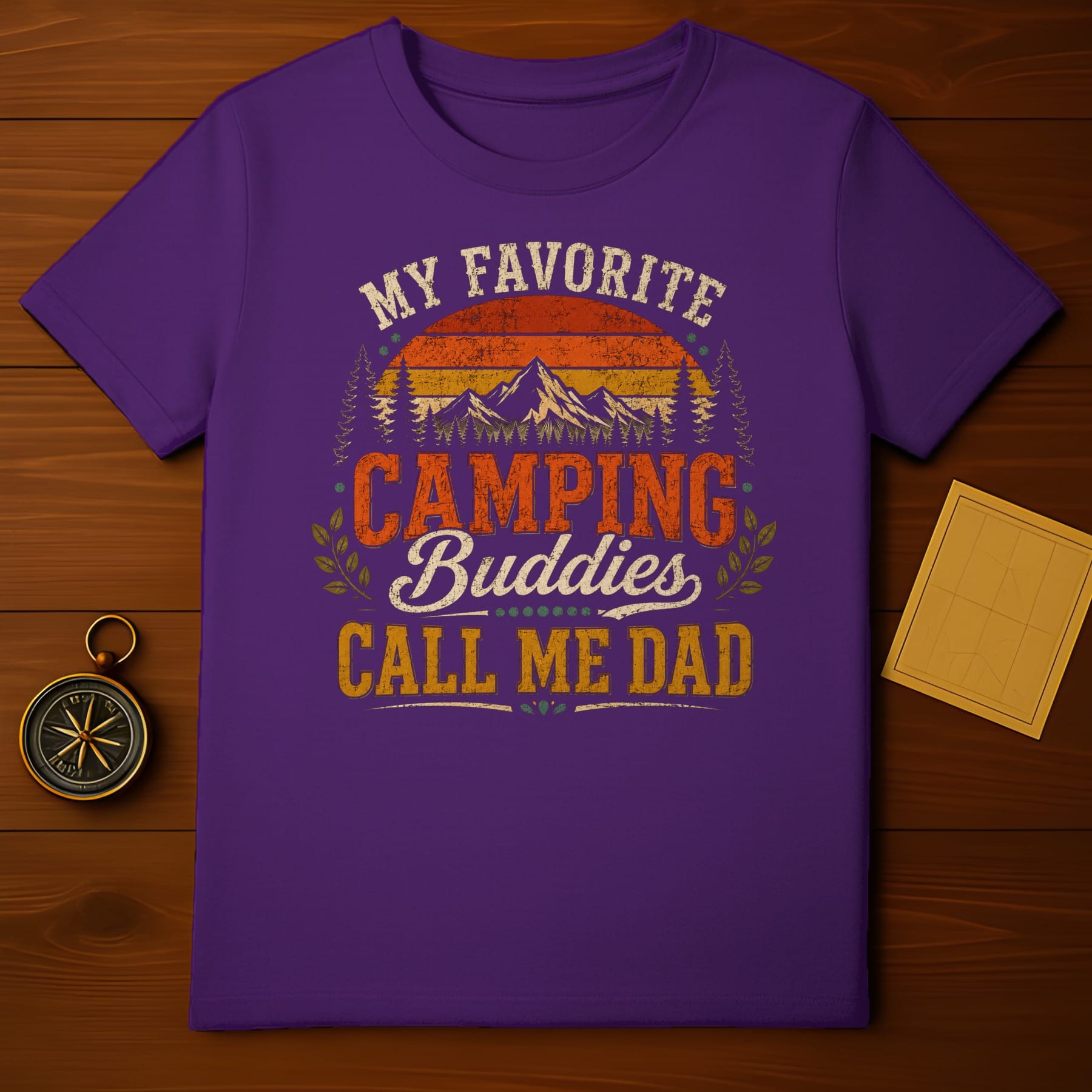 Purple t-shirt with "My Favorite Camping Buddies Call Me Dad" text and vintage mountain graphic.