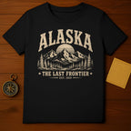 Black t-shirt with "Alaska The Last Frontier Est. 1959" and mountain graphic.