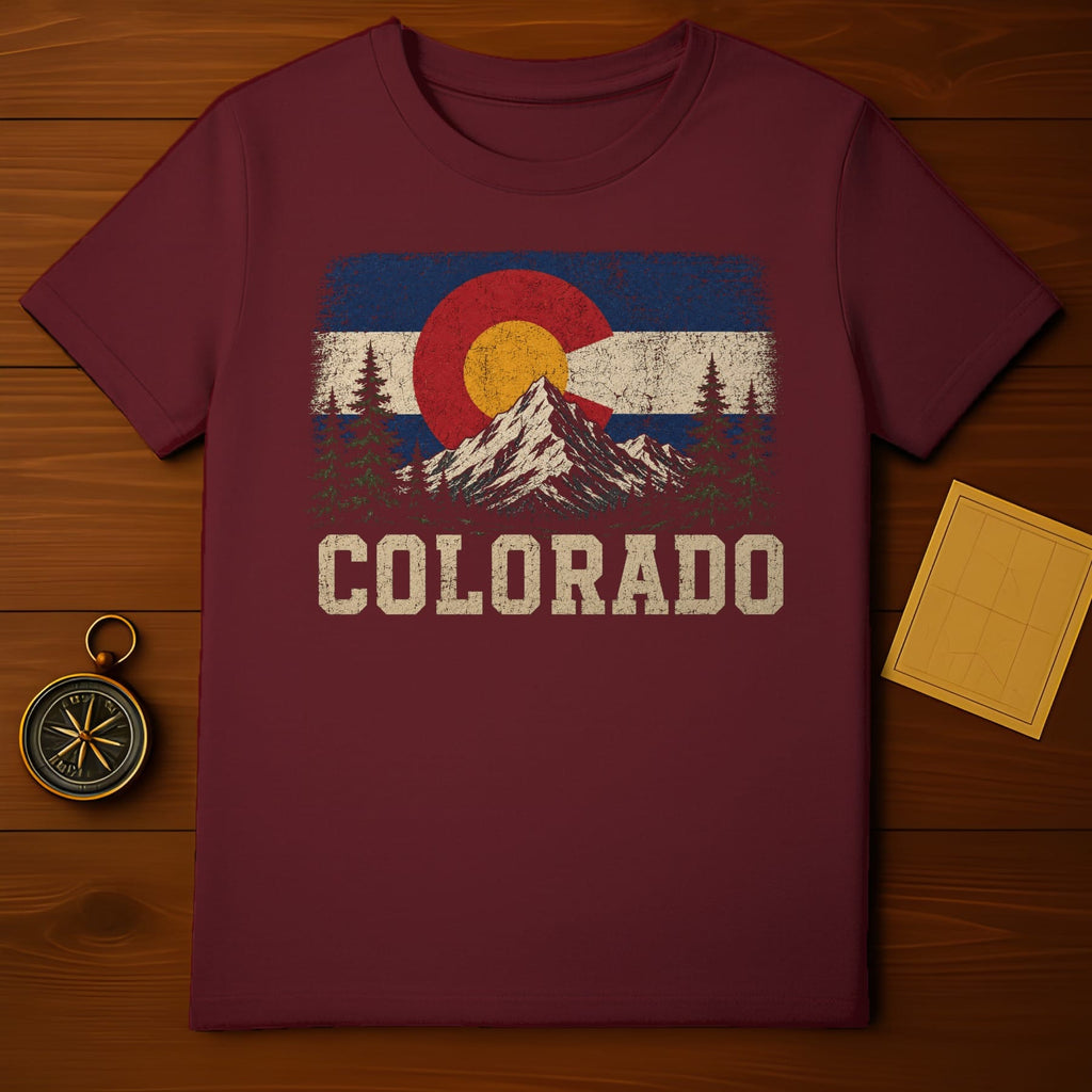 Maroon t-shirt with distressed Colorado flag graphic featuring mountains and trees.