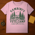 Pink t-shirt with green "GAMBINI'S YUTE CAMP" graphic and camping scene.