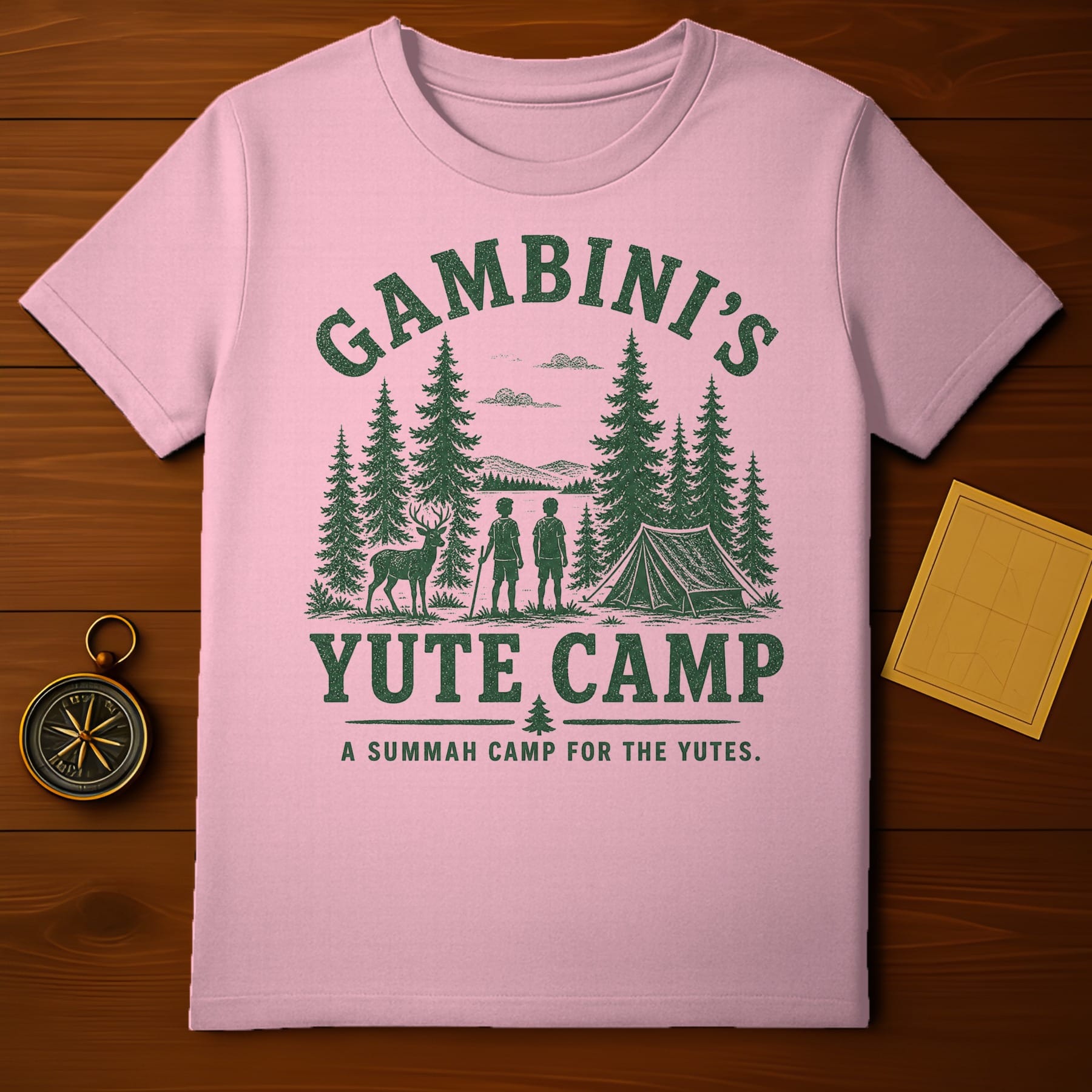 Pink t-shirt with green "GAMBINI'S YUTE CAMP" graphic and camping scene.