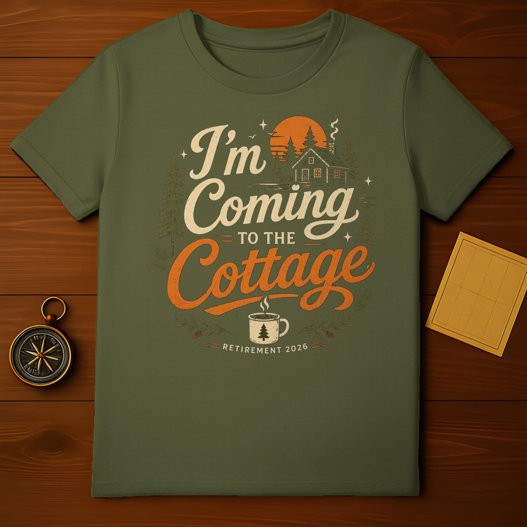Green t-shirt with "I'm Coming to the Cottage" text and a cabin scene.