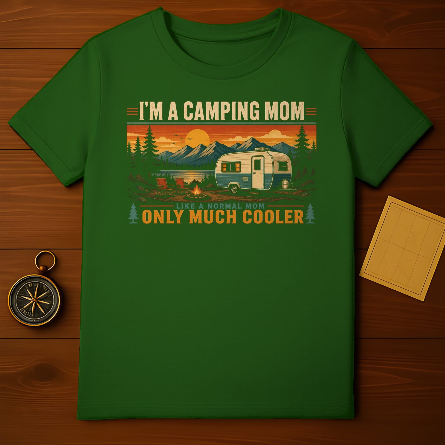 Green t-shirt with "I'm A Camping Mom Like A Normal Mom Only Much Cooler" text and mountain landscape.