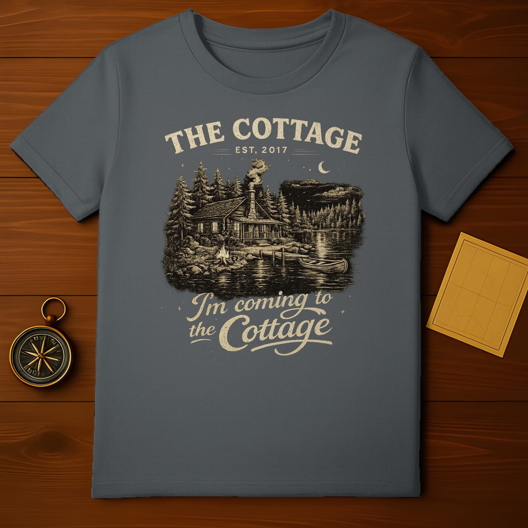 Dark t-shirt with "The Cottage Est. 2017 I'm coming to the Cottage" and a cabin scene.