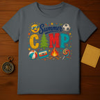 Gray t-shirt with "Summer Camp" text and icons of sun, soccer ball, beach ball, campfire, and lollipop.