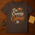 Brown t-shirt with "I'm Coming to the Cottage" text and woodland design.