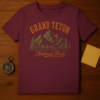 Maroon t-shirt with "Grand Teton National Park" text and mountain graphic.