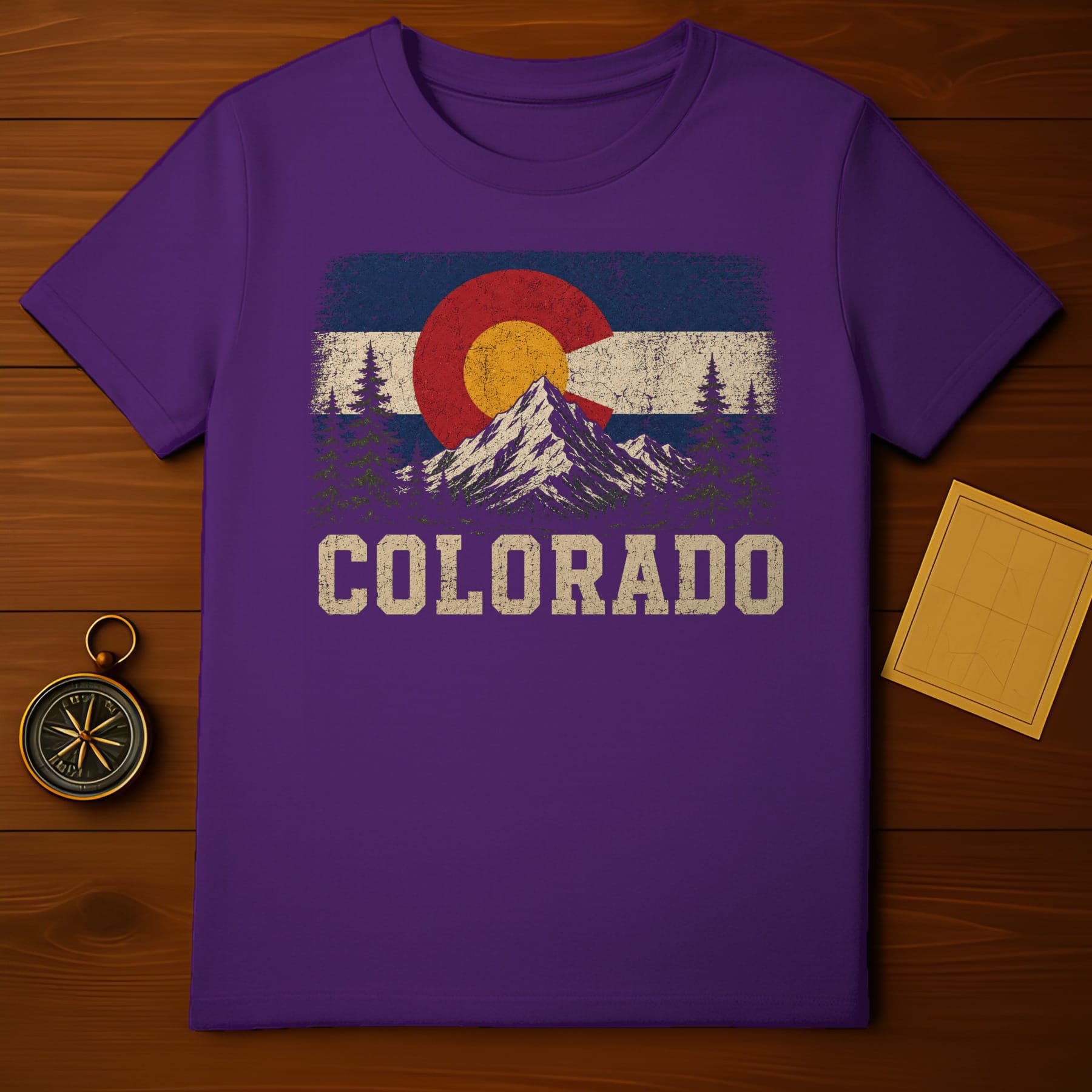 Purple t-shirt with vintage Colorado flag graphic and mountain landscape.