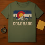T-shirt with distressed Colorado flag, mountains, trees, and text.
