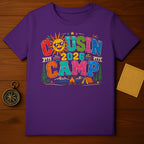 Purple t-shirt with "Cousin Camp 2026" graphic and camping scene.
