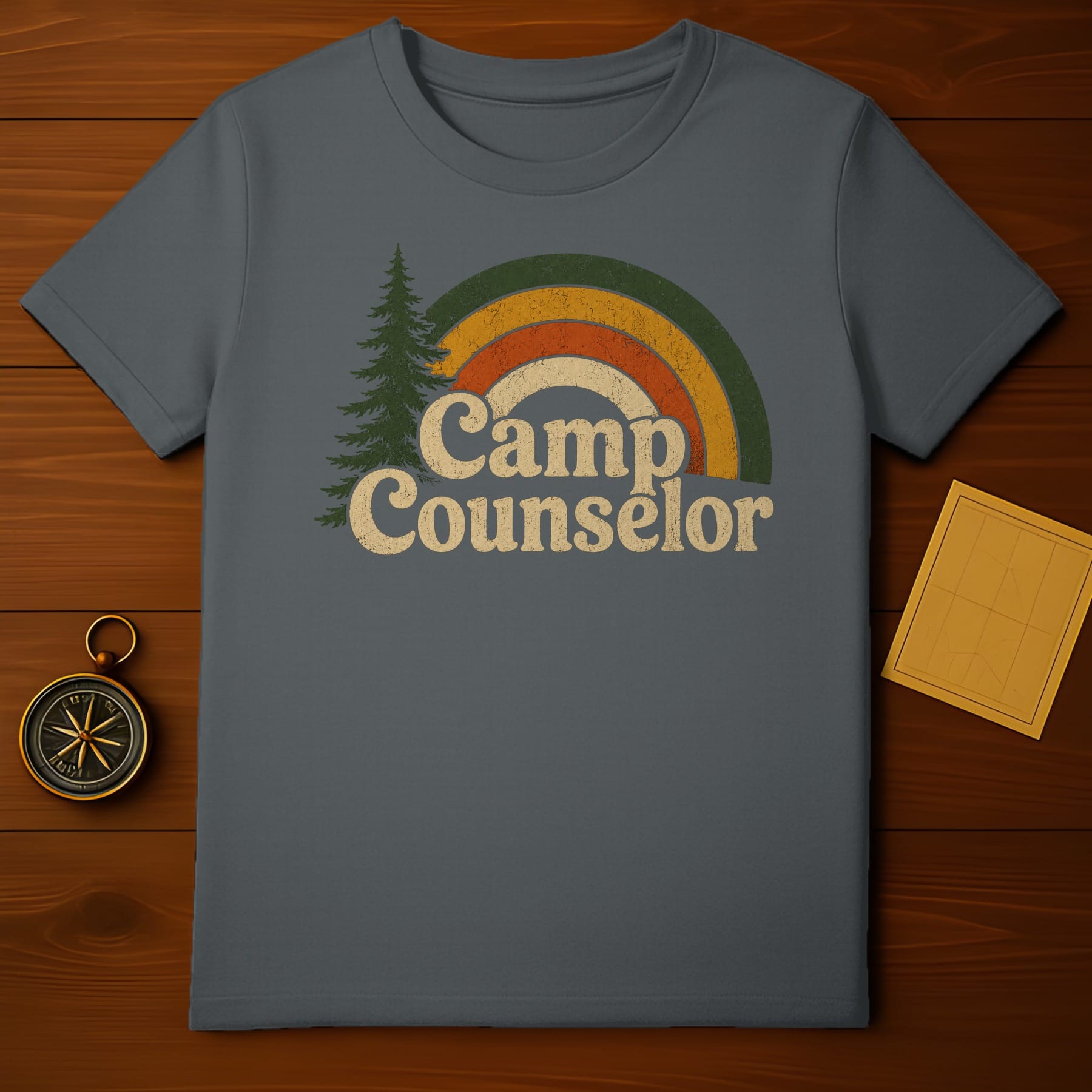 Dark grey t-shirt with "Camp Counselor" text, tree, and a retro rainbow.