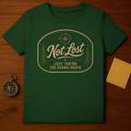 Green t-shirt with oval emblem reading "Not Lost Just Taking The Scenic Route".