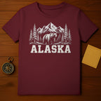 Maroon t-shirt with distressed graphic of bear, pine trees, and mountains.