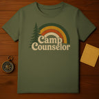 Olive green t-shirt with vintage "Camp Counselor" text and distressed rainbow graphic.