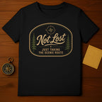 Black t-shirt with oval graphic: "Not Lost Just Taking The Scenic Route" and compass.
