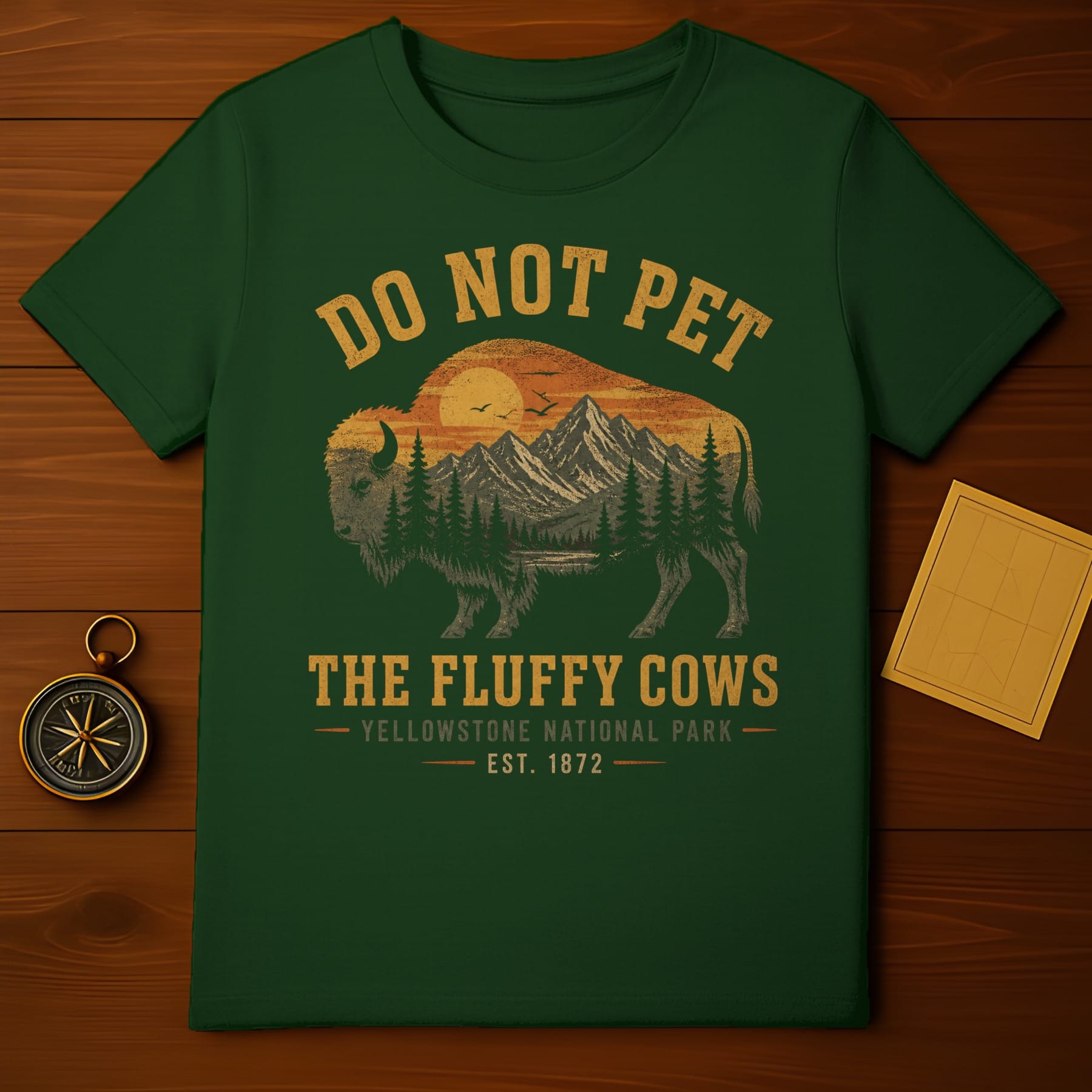 Green t-shirt with "Do Not Pet The Fluffy Cows Yellowstone National Park 1872" text and bison silhouette.