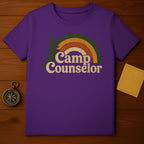Purple t-shirt with retro rainbow and "Camp Counselor" text.