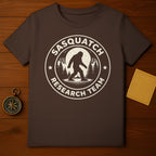 Sasquatch Research Team Bigfoot Silhouette Moon Forest product type
Sasquatch,Bigfoot,Research Team,Cryptozoology,Mythical Creature,Forest,Pine Trees,Moon,Full Moon,Silhouette,Outdoors,Adventure,Wilderness,Cryptid,Paranormal,Legendary,Brown Shirt,Graphic Tee,Nature,Expedition